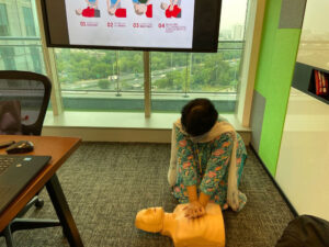 Women giving First aid to dummy