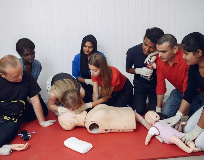 CPR training on manikins during the Red Cross First Aid class.