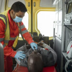 A healthcare professional checking a injured patient's health condition